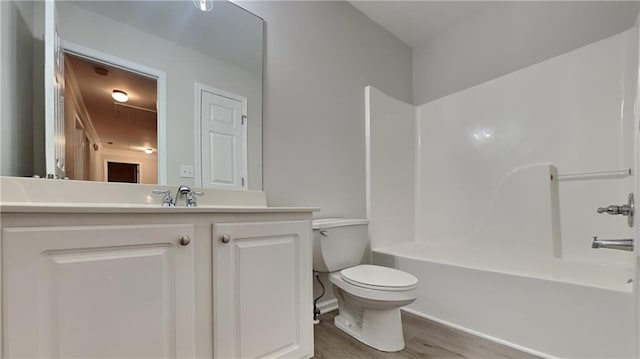 full bathroom with vanity, wood-type flooring, bathtub / shower combination, and toilet