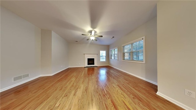 unfurnished living room with ceiling fan and light hardwood / wood-style floors