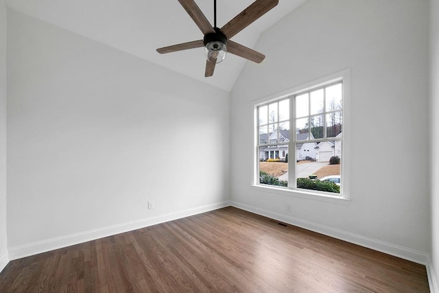 spare room featuring vaulted ceiling, dark wood-type flooring, and ceiling fan