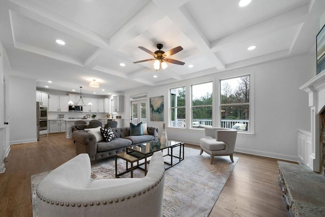 living room with wood-type flooring, coffered ceiling, and beam ceiling