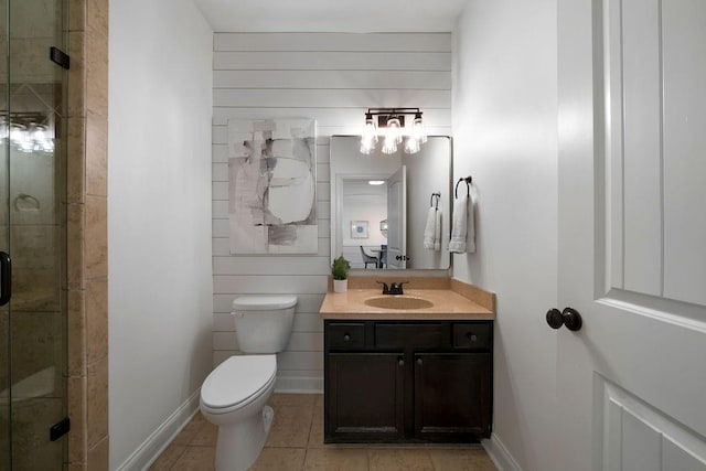 bathroom with vanity, toilet, a shower with shower door, and tile patterned flooring