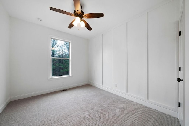 carpeted empty room featuring ceiling fan