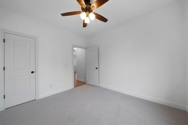 unfurnished bedroom with ceiling fan and light carpet