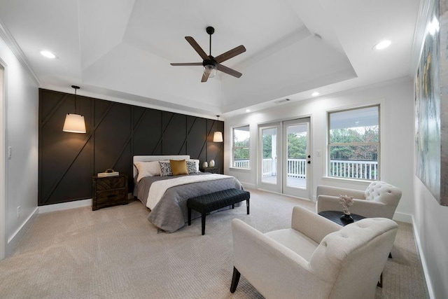 bedroom with crown molding, ceiling fan, a tray ceiling, access to outside, and light colored carpet