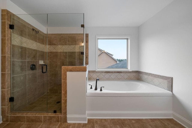 bathroom featuring separate shower and tub