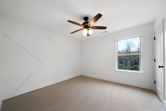 unfurnished room with light colored carpet and ceiling fan