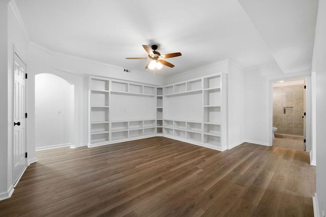 empty room with ceiling fan, ornamental molding, and dark hardwood / wood-style flooring