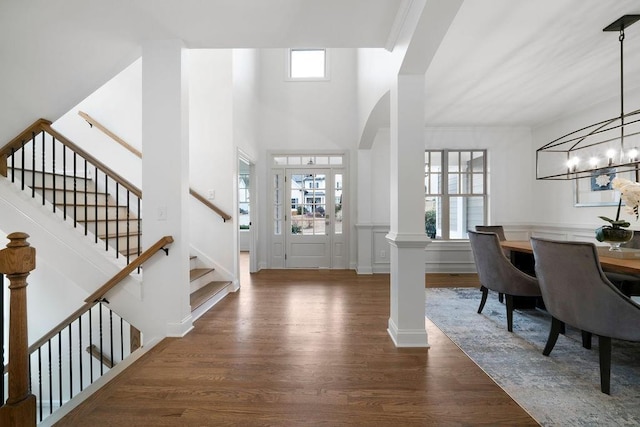 entryway with dark hardwood / wood-style floors and decorative columns