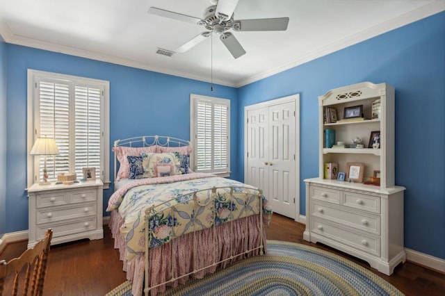 bedroom with ceiling fan, dark wood-type flooring, ornamental molding, and a closet