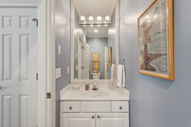 bathroom with crown molding, an inviting chandelier, and vanity