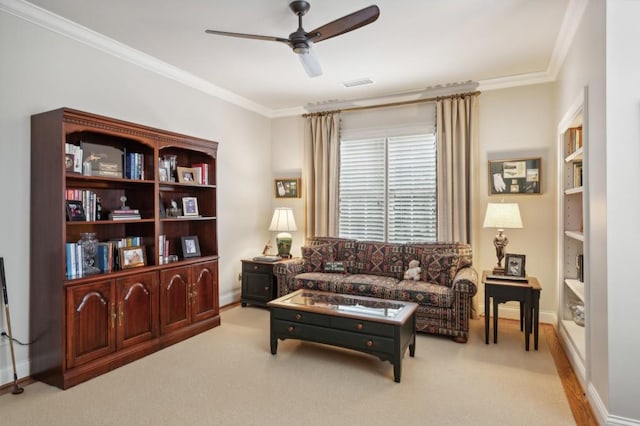 living room featuring ceiling fan, light carpet, and ornamental molding