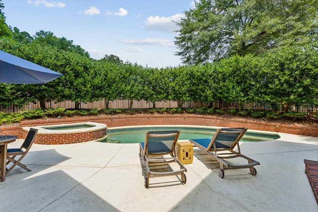 view of swimming pool with an in ground hot tub and a patio area