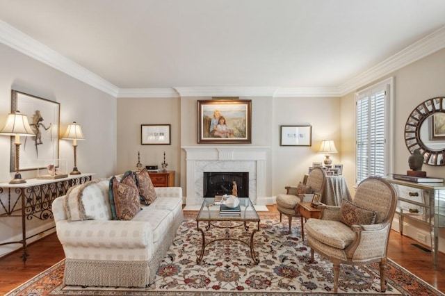 living room with hardwood / wood-style floors, ornamental molding, and a premium fireplace