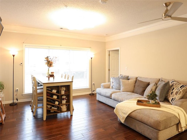 living room featuring plenty of natural light, ornamental molding, dark hardwood / wood-style floors, and a textured ceiling