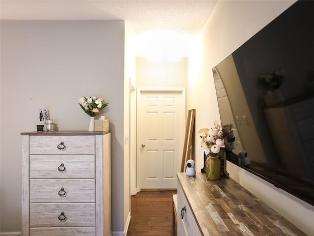 interior space with dark hardwood / wood-style floors and a textured ceiling