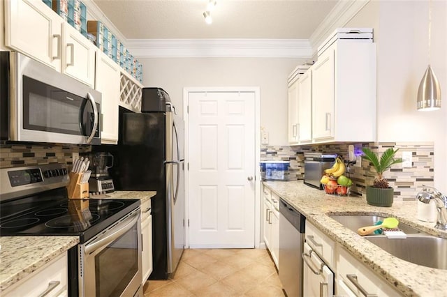 kitchen featuring crown molding, stainless steel appliances, light stone countertops, and sink