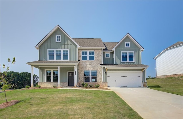 craftsman inspired home featuring a garage, a front yard, and covered porch