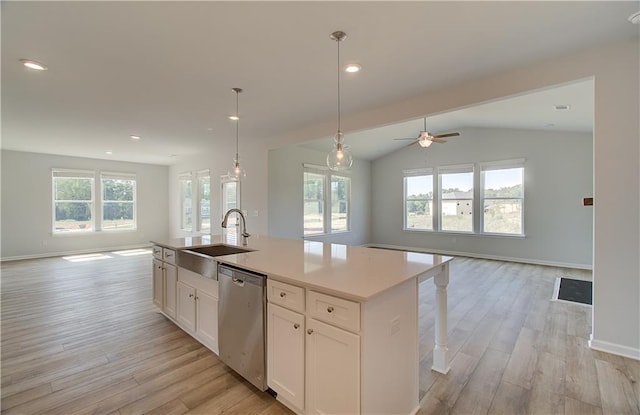 kitchen featuring sink, white cabinetry, an island with sink, stainless steel dishwasher, and light wood-type flooring