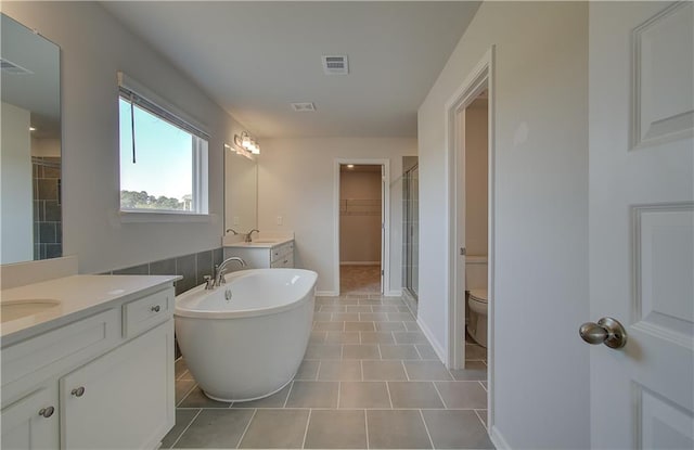 full bathroom featuring vanity, plus walk in shower, tile patterned floors, and toilet