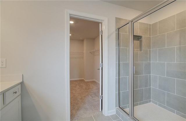 bathroom with vanity, tile patterned flooring, and a shower with door