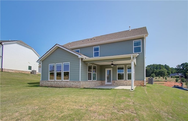 rear view of house with cooling unit, a yard, a patio area, and ceiling fan