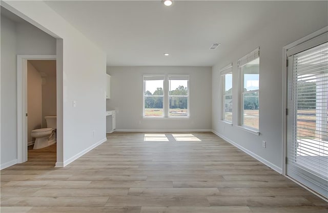 unfurnished living room featuring light wood-type flooring