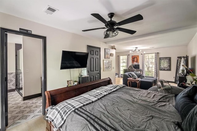 bedroom featuring a chandelier, a ceiling fan, baseboards, and light carpet