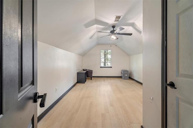 additional living space featuring light wood-style flooring, ceiling fan, vaulted ceiling, and baseboards