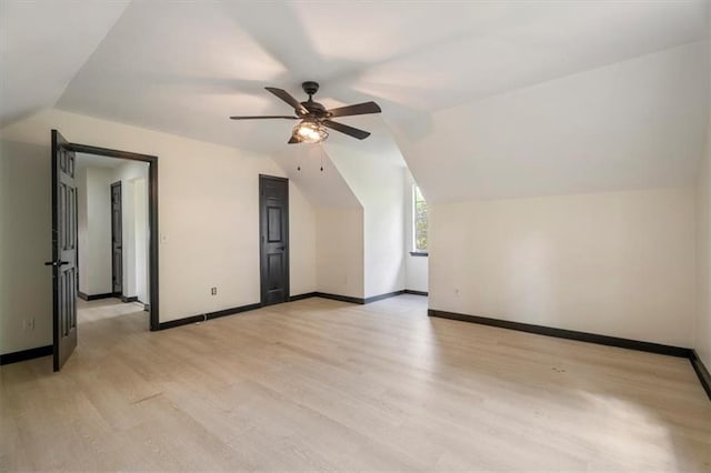 additional living space with a ceiling fan, light wood-type flooring, lofted ceiling, and baseboards