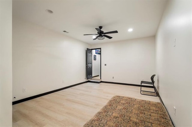 spare room with a ceiling fan, light wood finished floors, recessed lighting, and baseboards