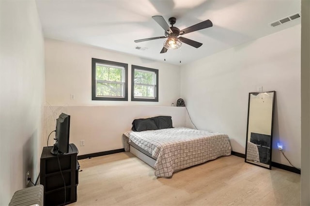 bedroom featuring wood finished floors, baseboards, and ceiling fan
