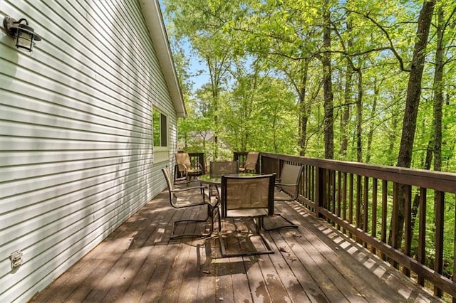 wooden terrace featuring outdoor dining space