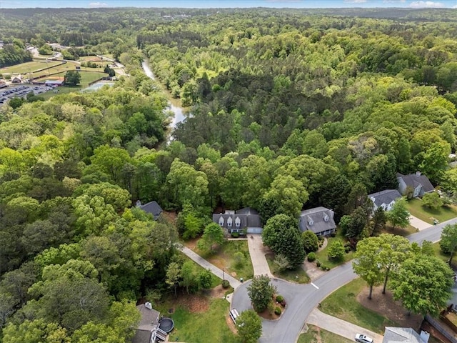 aerial view of property and surrounding area with a forest