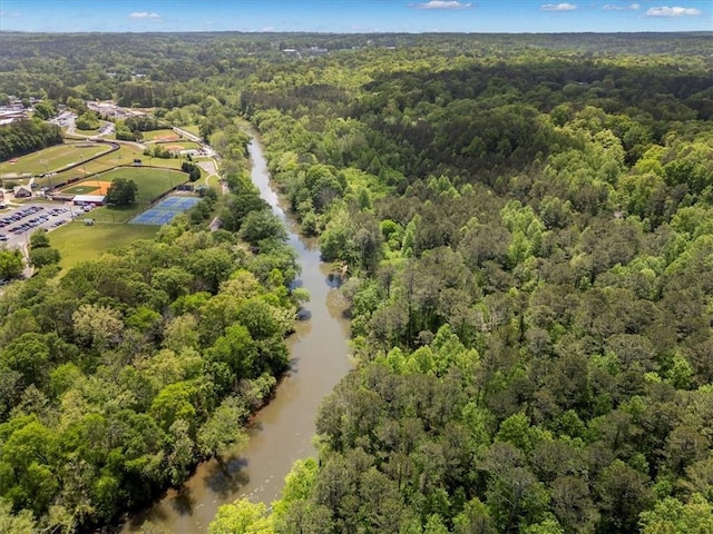 bird's eye view of a heavily wooded area and a nearby body of water