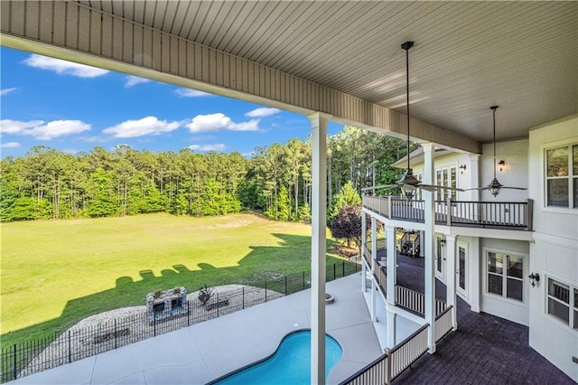 view of patio featuring a fenced in pool, fence, and a balcony