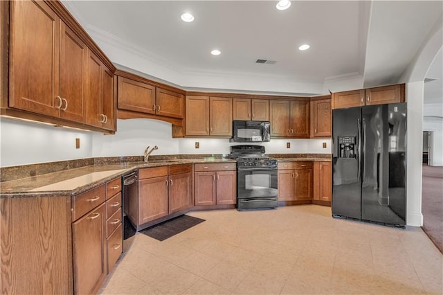 kitchen featuring ornamental molding, brown cabinets, black appliances, a sink, and recessed lighting