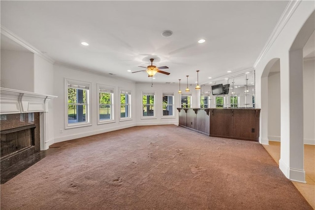 unfurnished living room with ornamental molding, a high end fireplace, and baseboards