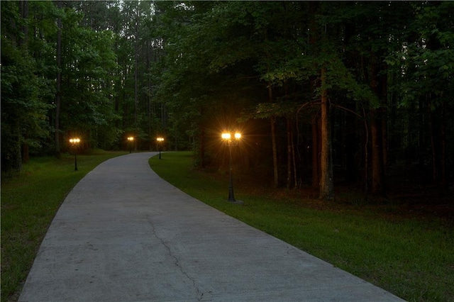 view of community with driveway and a lawn