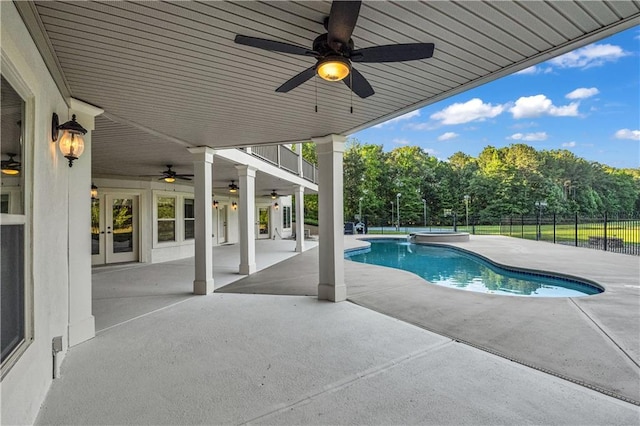 view of pool with a fenced in pool, ceiling fan, fence, french doors, and a patio area