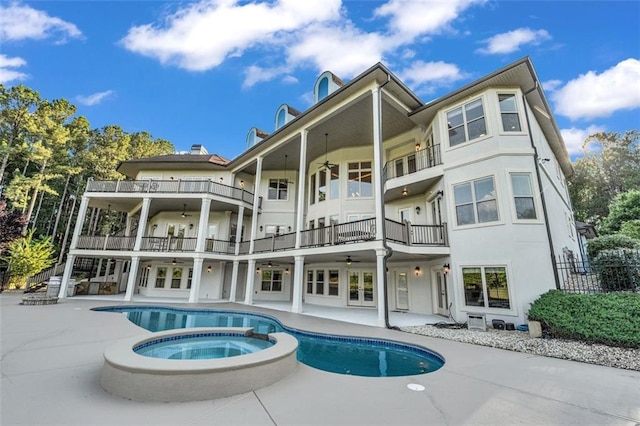 rear view of property featuring a ceiling fan, a patio, and stucco siding