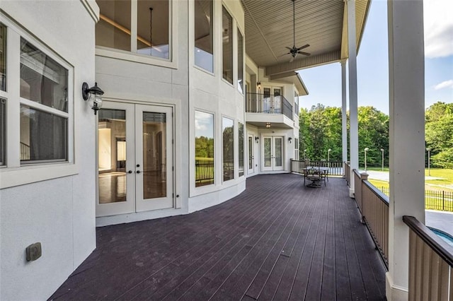 deck with french doors and a ceiling fan