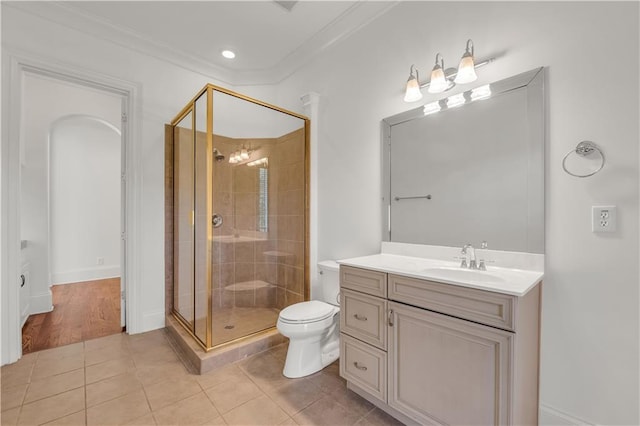 bathroom with ornamental molding, a stall shower, vanity, and tile patterned floors