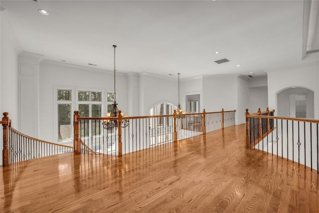 corridor featuring recessed lighting, a notable chandelier, an upstairs landing, light wood-style floors, and visible vents