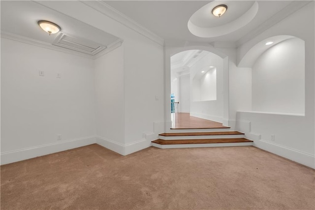 interior space featuring crown molding, baseboards, and carpet flooring