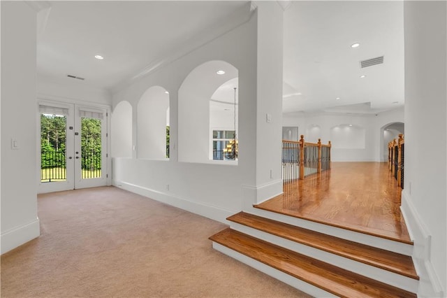 interior space with carpet floors, recessed lighting, visible vents, and arched walkways