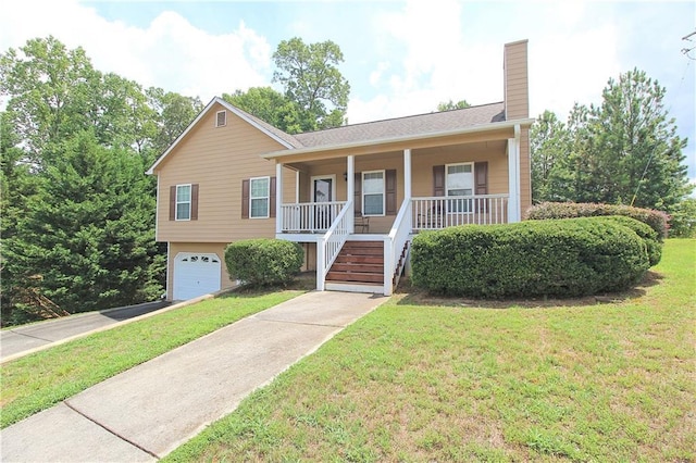 view of front of property featuring a garage, a porch, and a front lawn