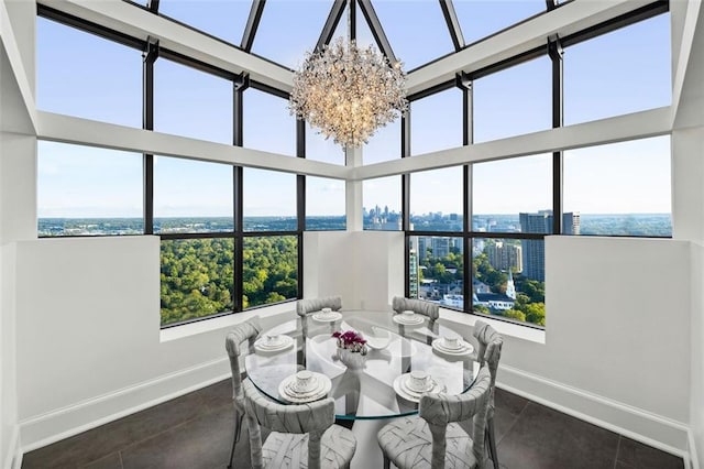 dining space with a high ceiling and an inviting chandelier