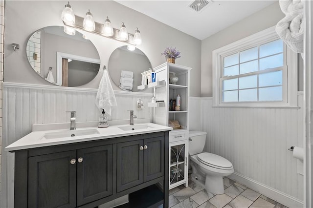 bathroom featuring vanity and toilet