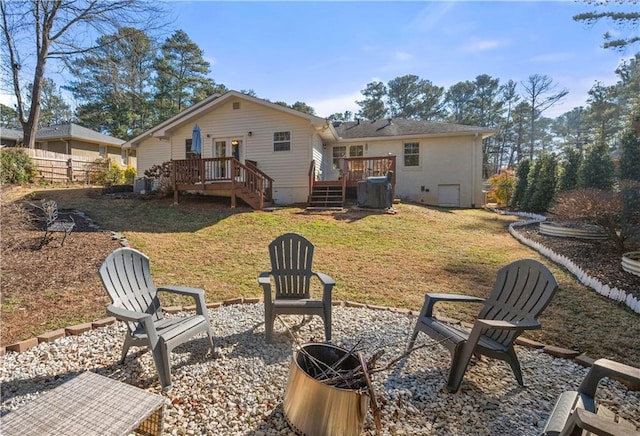 back of house featuring a deck and a lawn