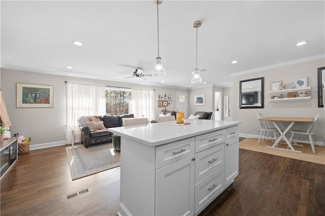 kitchen with white cabinetry, decorative light fixtures, dark hardwood / wood-style floors, and a kitchen island